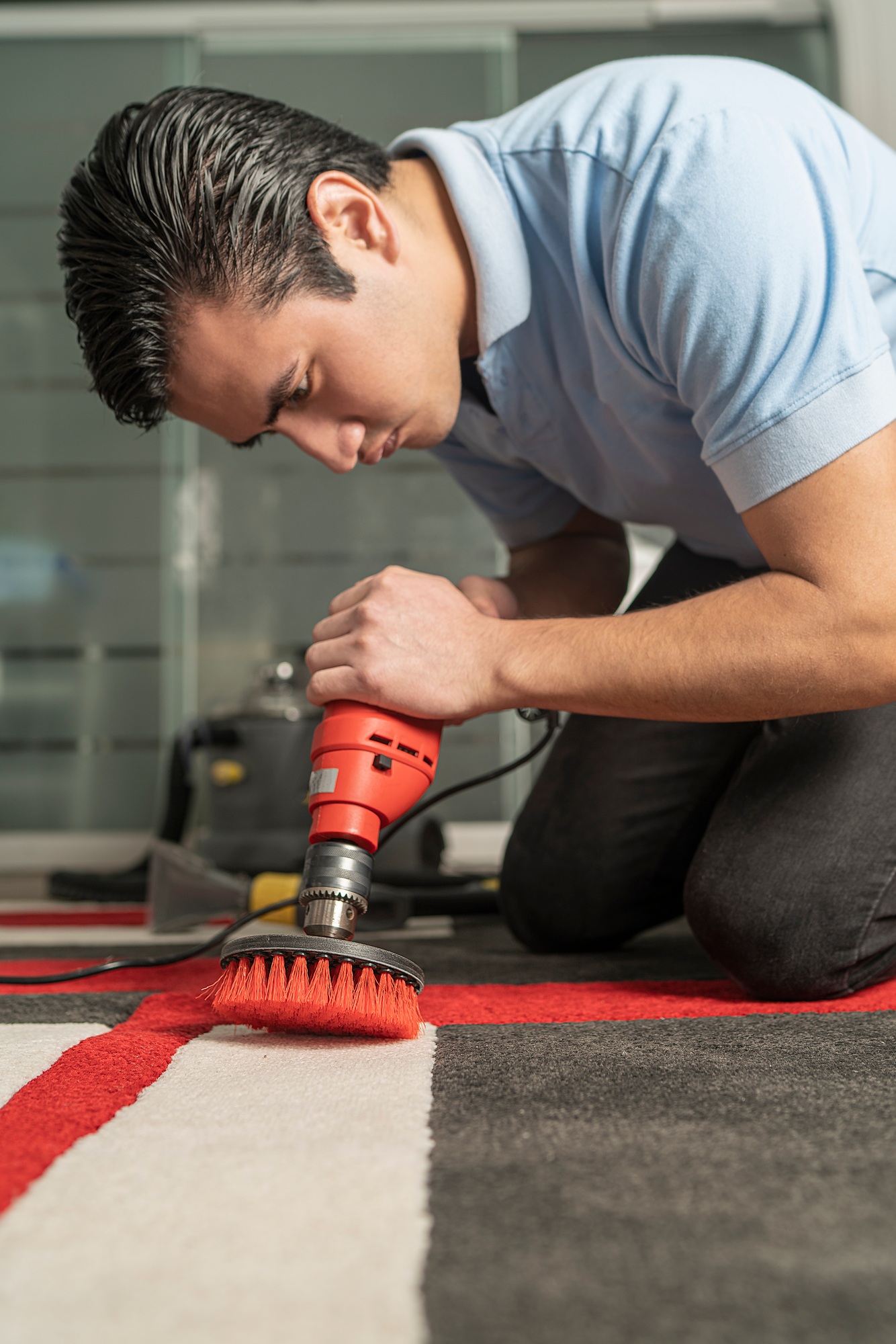 Laundry personnel cleaning carpet with special equipment